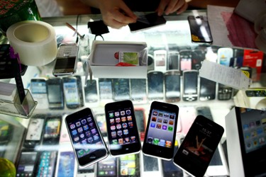 Fake iPhones are displayed at a mobile phone stall in Shanghai.