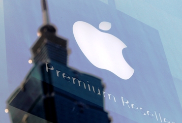 The Apple logo is seen against the reflection of Taiwan's landmark building Taipei 101.