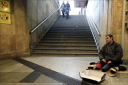 A beggar sits in an underpass in downtown Budapest.