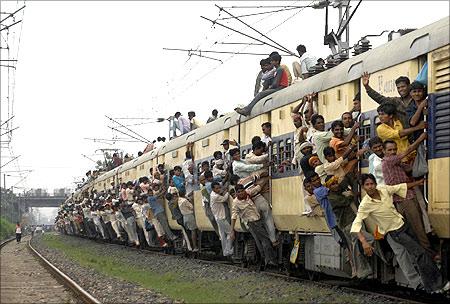 Passengers travel in an overcrowded train in Patna.