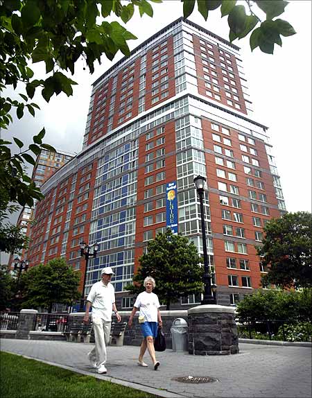 Pedestrians walk past the new Solaire building, an environmentally engineered or green residential tower in the lower Manhattan neighborhood.