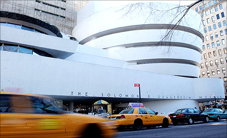 Traffic moves past the front of the Solomon R. Guggenheim Museum in New York City.