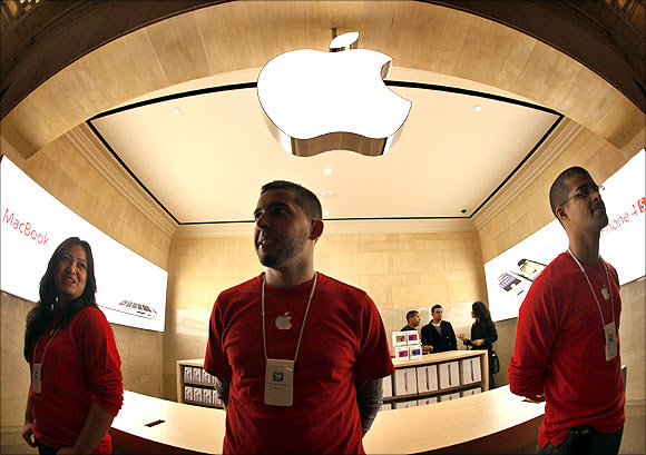 Apple employees stand inside the newest Apple store inside York City's Grand Central Station.