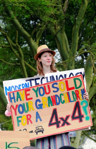 Environmental activist holds up a sign during a demonstration.