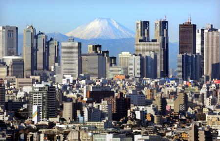 Japan's Mt Fuji, covered with snow, is seen through Shinjuku skyscrapers in Tokyo.