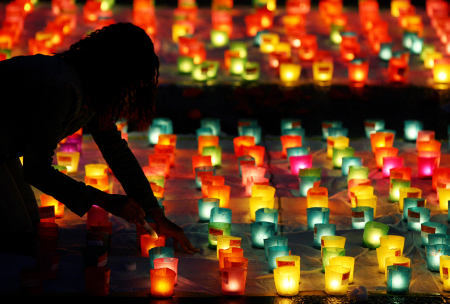 A volunteer sets up candles during Swiss national day in Berne.