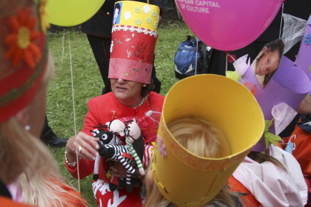 Norway's Queen Sonja (facing camera) celebrates her birthday while wearing a paper crown made by a child during a garden party with children in Stavanger, southwest Norway.