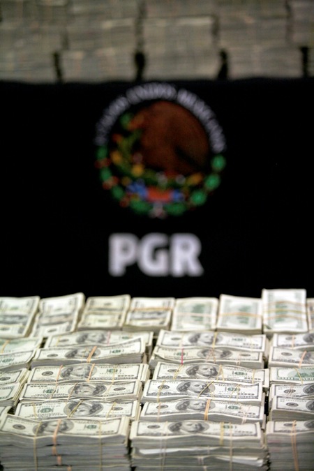 Stacks of U.S. hundred dollar bills are displayed during a presentation to the media in Mexico City.