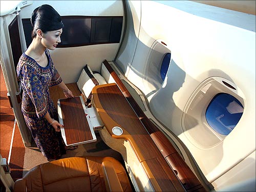 A Singapore Airlines flight attendant demonstrates the features of the first class suite.