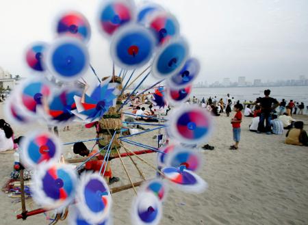 People relax on a beach in Mumbai.