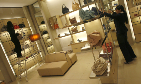 Employees adjust products inside their showroom at the Emporio mall in New Delhi.
