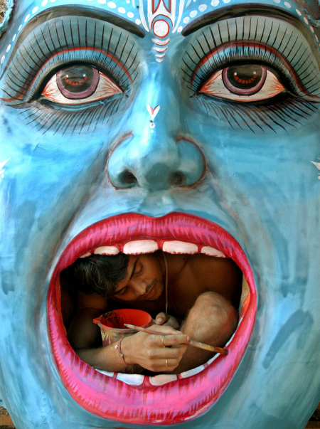 An artisan gives finishing touches to the idol of Lord Krishna in Chandigarh.