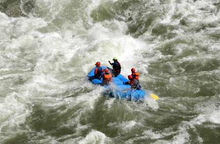 Tourists participate in white water rafting in the Chenab River in Thathri, near Jammu.