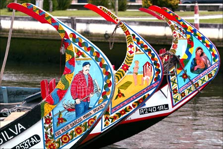 Decorated prows of traditional boats on one of the Aveiro city canals in central Portugal.