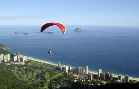 A paraglider soars through the air after jumping off Pedra Bonita in Rio de Janeiro.