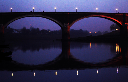 Silhouette of an old bridge over the Kupa River seen at dusk in central Croatian town of Sisak.
