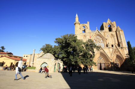 A youth skates past the Lala Mustafa Masha Mosque and a cathedral built by the Lusignans in Famagusta, north Cyprus.