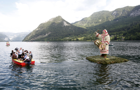 A boat decorated with a traditional carnival figure is seen during a parade in the village of Grundlsee.