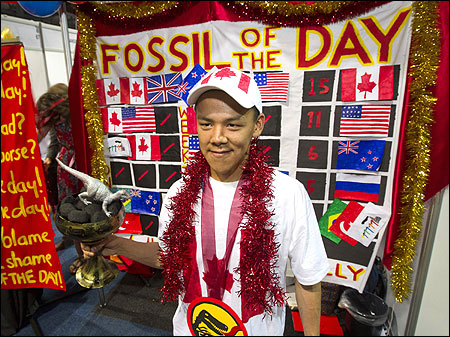 The Colossal Fossil mock award is presented to activist Jordan Konek, an Inuit youth delegate, during COP17 in Durban.