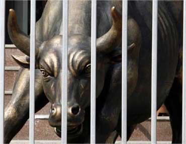 A sculpture of a bull is seen through the gates of Bombay Stock Exchange.