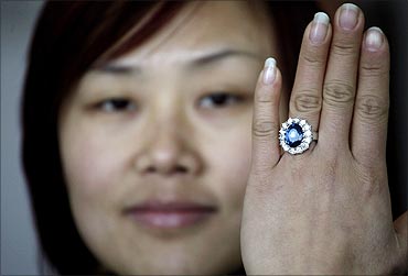 A woman shows a replica of the British royal engagement ring at a jewellery factory in Yiwu.