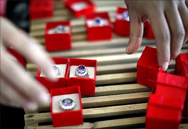 An employee packages replicas of the British royal engagement ring at a jewellery factory.