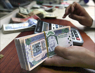 A Saudi money exchanger counts Saudi riyals in Riyadh.