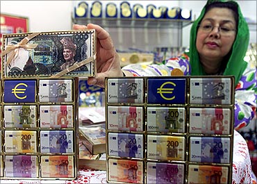 Sharifah Azwan Jamulullail arranges chocolates wrapped with currency notes.