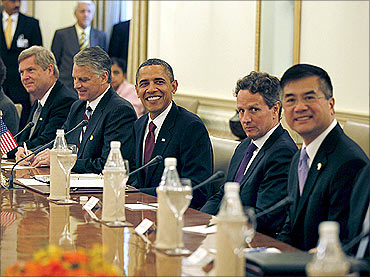 U.S. President Barack Obama sits with members of his delegation during a bilateral meeting with India's Prime Minister Manmohan Singh at Hyderabad House in New Delhi, November 8, 2010. With Obama are Treasury Secretary Tim Geithner (2nd R) and Commerce Secretary Gary Locke (R). Obama hinted on Monday the United States could lend support to India's demand to have a permanent seat on the U.N. Security Council, a move that could help cement growing ties with the emerging global power.