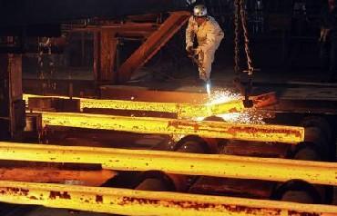 A labourer works at a steel factory workshop in Hefei, Anhui province in China