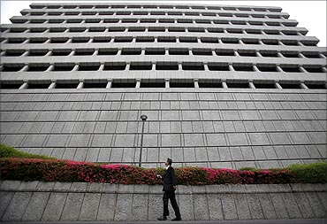 A man walks past the Bank of Japan headquarters building in Tokyo.