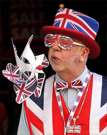 A man dressed in British union flag clothing promotes a souvenir shop in Piccadilly Circus.