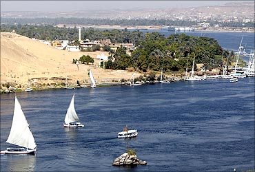 Traditional Egyptian Felucca boats sail on the Nile river in the southern Egyptian city of Aswan.