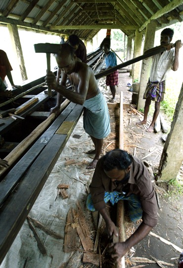 Workers give finishing touches to a boat on the eve of snake boat race at Alleppey near Kochi in Kerala.