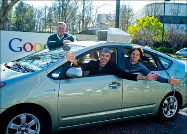 (L to R) Eric Schmidt, Larry Page and Sergey Brin in a self-driving car in a photo taken earlier on January 20 posted on Schmidt's blog.