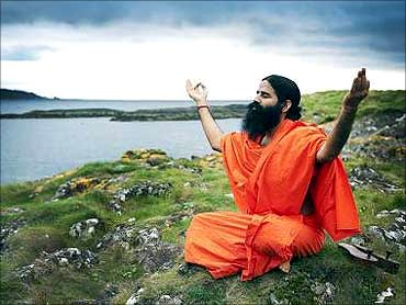 Baba Ramdev worships on Little Cumbrae during a hawan to bless the island.