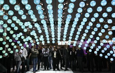 Visitors watch a presentation about cloud computing at the IBM booth at the CeBIT computer fair in Hanover