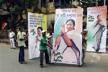 TMC supporters carry Mamata Banerjee's cutouts.
