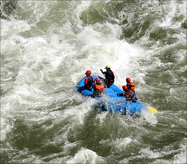 Tourists enjoy white water rafting in river Chenab.