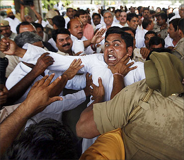 Farmers scuffle with police during a protest march at Noida.