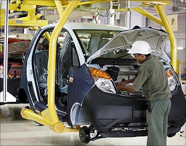 An employee works inside the newly inaugurated plant for the Tata Nano car at Sanand.