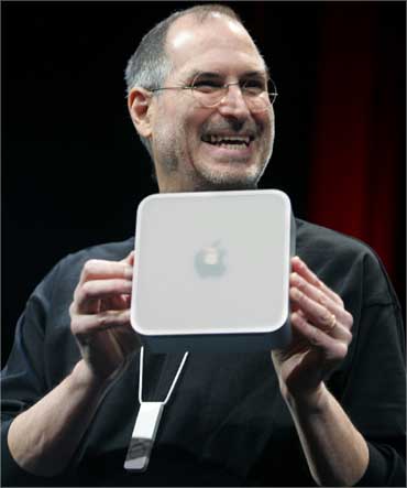 Jobs holds up Apple's Mini Mac computer on January 11, 2005.