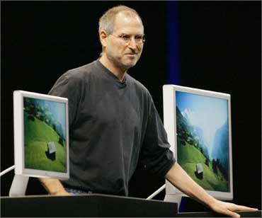 Jobs stands with several Apple flat panel displays on June 28, 2004.