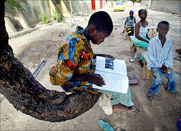 A boy reads a school book at a village just outside Mali's capital Bamako