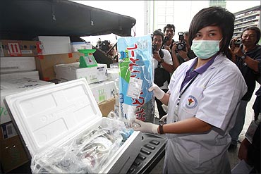 An official from Thailand's Food and Drug Administration takes a sample to test food from Japan.