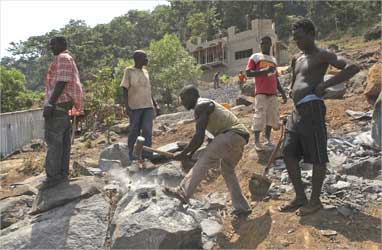 Labourers work at a construction site above Sierra Leone's capital Freetown.
