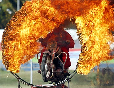 An Indian army soldier performs a motorcycle stunt through a ring of fire in Ahmedabad.