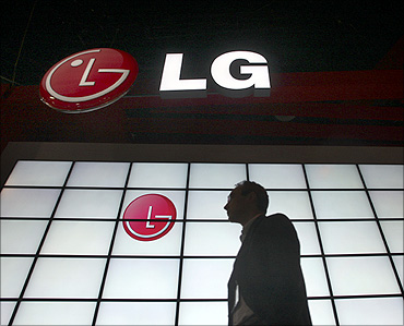 A man passes by a LG Electronics booth at a consumer electronics show.