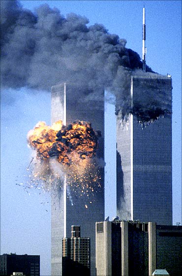 The World Trade Center south tower (L) bursts into flames during the Sept 11 attacks.