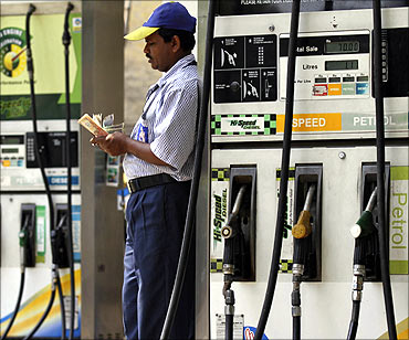 An employee counts money at a fuel station in Kolkata.